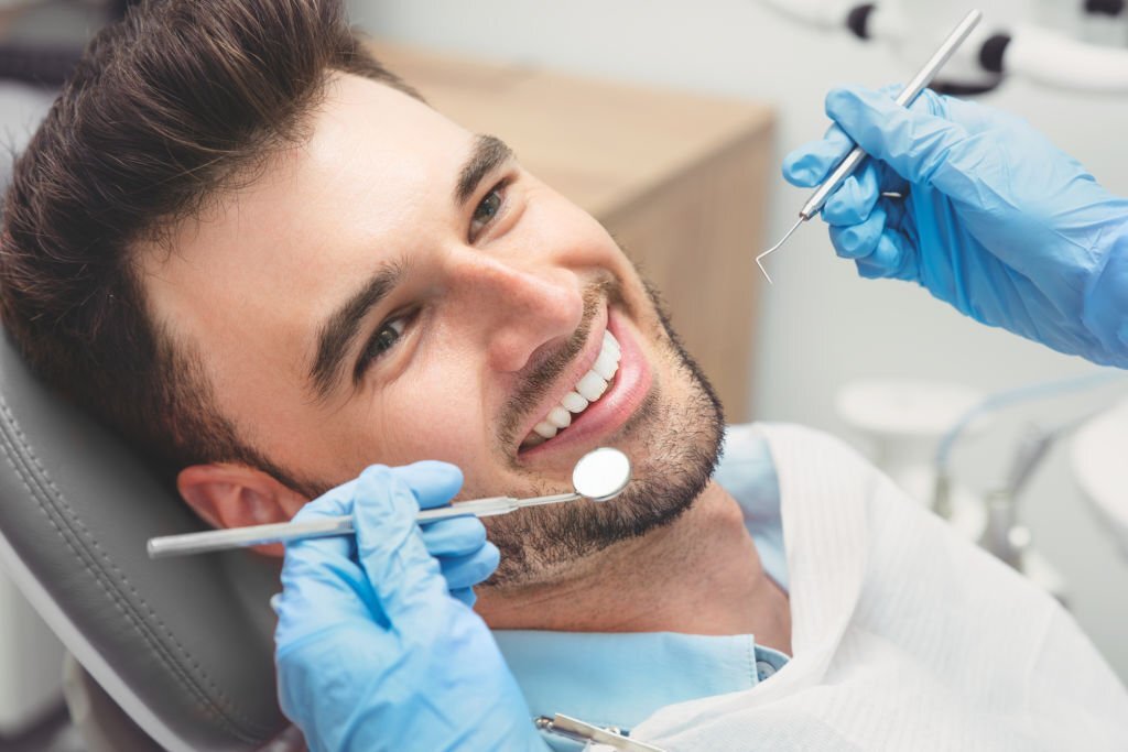 Man having teeth examined at dentists. Overview of dental caries prevention